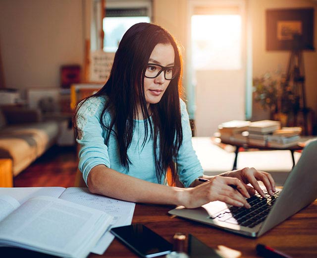A person typing on a laptop.